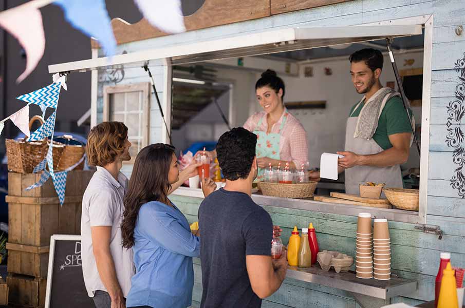 Waiter taking order from customer at counter